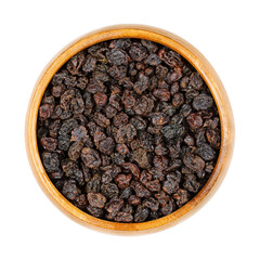 Zante currants, in a wooden bowl. Small raisins, also known as Corinth raisins or simply currants. Dried fruits of the small, sweet, seedless grape cultivar Black Corinth, Vitis vinifera. Food photo.