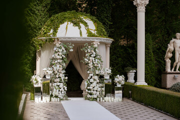 Wedding arch with white flowers arrangements.Wedding decor.