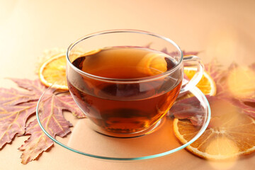 Concept of hot drink with tea on beige background