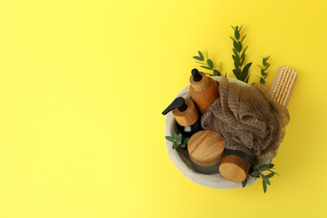 Concept of gift with basket of cosmetics on yellow background
