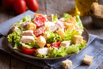 Green vegetable salad with lattuce, chicken and croutons. Healthy food concept