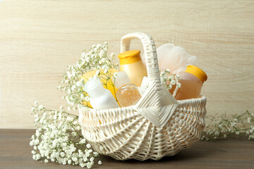 Concept of gift with basket of cosmetics on wooden table