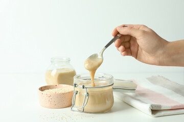Concept of tasty food with tahini sauce on white table