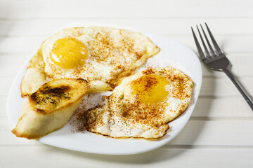fried eggs, baguette with herb butter and coffee