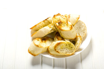toasted baguette with herb butter on a wooden table