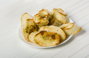 toasted baguette with herb butter on a wooden table