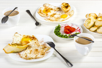 fried eggs, baguette with herb butter and coffee
