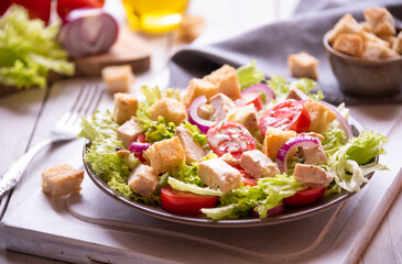 Caesar salad with vegetables, chicken and croutons