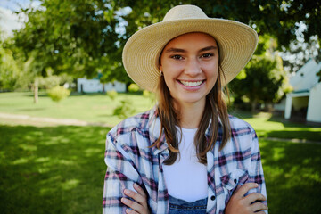 Caucasian female farmer standing outdoors with arms crossed