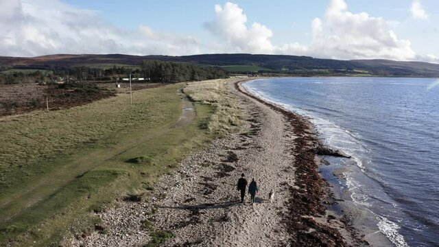Drone shot flying over a beach on the Kintyre peninsula in Scotland on a sunny day