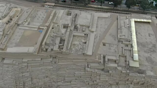 Century-old Pyramid Huaca Pucllana In The Bustling District Of Miraflores In Central Lima, Peru. aerial tilt panning