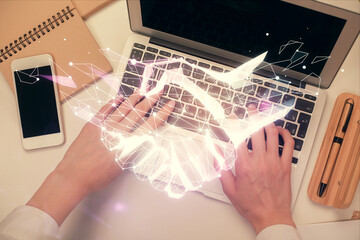 Double exposure of woman hands working on computer and handshake hologram drawing. Top View. Partnership concept.
