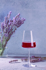 Rose wine with a bouquet of lavender flowers, a still life with a place for text