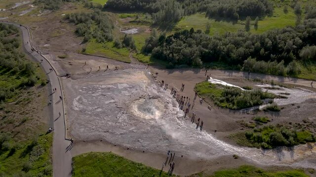 Aerial Cinematic footage of the Impressive Icelands Geysir Geisir in the Golden Circule, the geothermal activity and a attraction for tourists in Iceland	