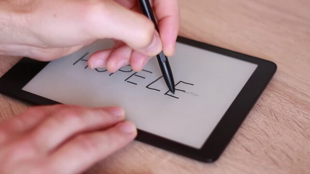 Writing HOPELESS on Electronic tablet and crossing LESS out