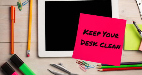 Image of keep your desk clean text on memo note over tablet on desk