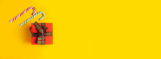 Gift, lollipop, candy on a yellow background. Banner.
