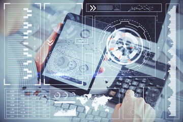 Double exposure of man's hand holding and using a digital device and data theme hologram drawing. Technology concept.