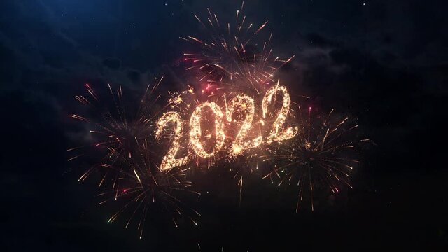 2022 Happy New Year greeting text with particles and sparks on black night sky with colored slow motion fireworks on background, beautiful typography magic design.