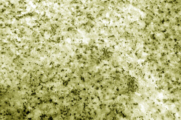 Granite surface as background with blur effect in yellow tone.