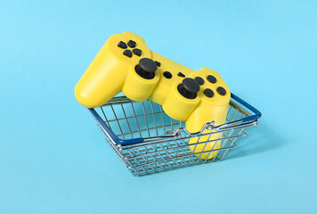 A small food basket with game control on a blue background. © gangster9686