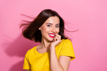 Photo of sweet charming young woman wear yellow outfit air blowing biting finger smiling isolated pink color background