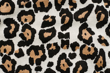 Animal print, leopard pattern fabric background in brown colors. High quality photo