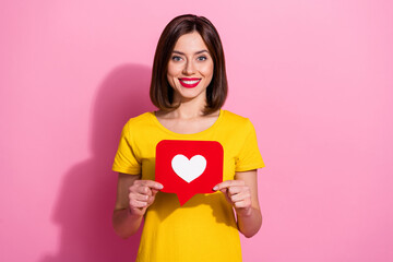 Photo of brunette flirty millennial lady hold like wear vivid t-shirt isolated on pastel pink color background - obrazy, fototapety, plakaty
