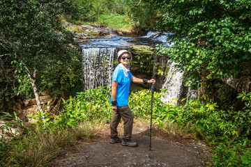 Women tourist relaxing on the waterfall, Phu Kradueng National Park, Loei Province, Thailand.