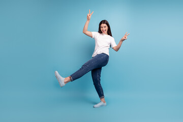 Fototapeta na wymiar Full body profile side photo of young excited girl show fingers peace v-symbol isolated over blue color background
