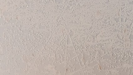 The frozen hood of the car. Frost on the metal surface of the car with the effect of a white fractal pattern.