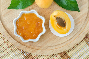 Homemade apricot face mask in a small white bowl and cotton pad. Natural beauty treatment and spa recipe. Top view, copy space.