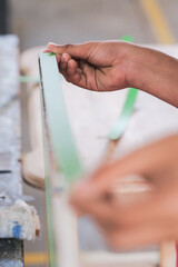 Obraz premium Young carpenters installing laminate for built-in cabinets at the workshop