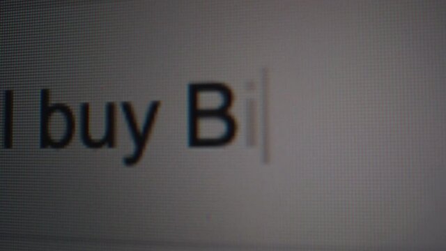 Tracking shot of the words "Should I buy Bitcoin?" being typed into a search machine