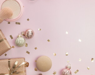 flat lay ,decorative cosmetics , gift boxes , christmas decorations on pink background, top view, copy space.