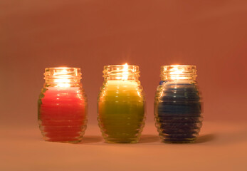Burning colorful candles for Christmas and New Year in the dark