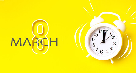 March 8th. Day 8 of month, Calendar date. White alarm clock with calendar day on yellow background....