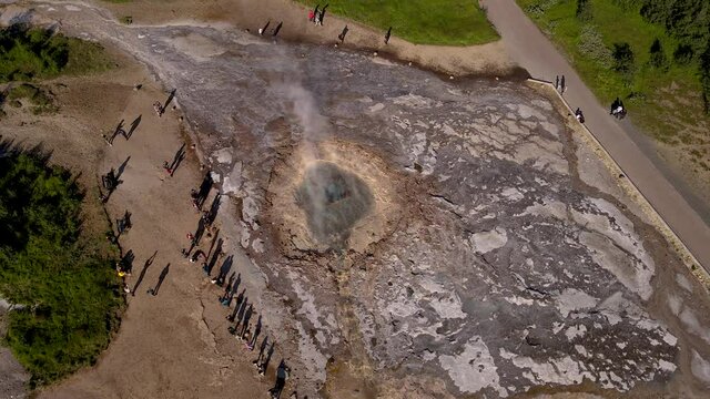 Aerial Cinematic footage of the Impressive Icelands Geysir Geisir in the Golden Circule, the geothermal activity and a attraction for tourists in Iceland	