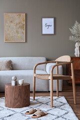 Modern composition in stylish living room interior with design chair, neutral sofa, coffee table, mock up poster frames, carpet, decoration and elegant personal accessories in home decor. Template.