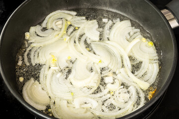 fry chopped onion rings in vegetable sunflower oil in a Teflon pan
