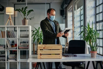 Businessman decorating his work desk with photo in frame