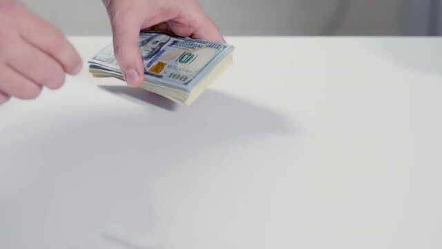 Two men concluding a deal as payment is made in cash