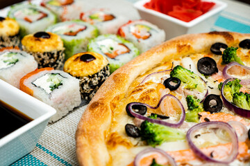 A beautiful set of sushi with pizza. 