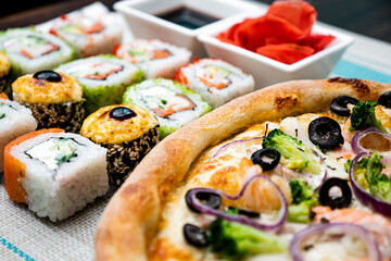 A beautiful set of sushi with pizza. 