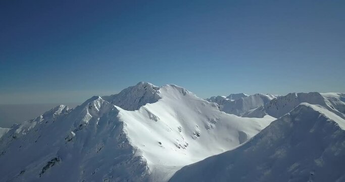 Beautiful Snowy Mountains In Romania - aerial shot