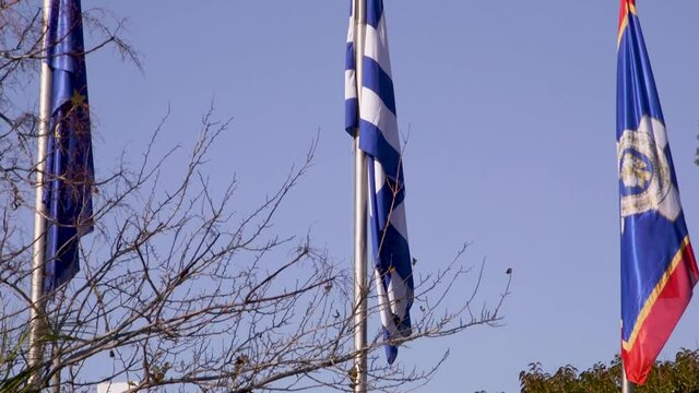 Detail shot of the flags of Athens, Greece and Europe.
