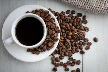 cup of coffee on a white background with coffee beans