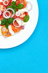 Tomato caprese salad, top view, close-up