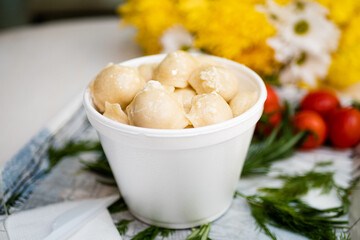 Cooked dumplings with cheese in a deep bowl