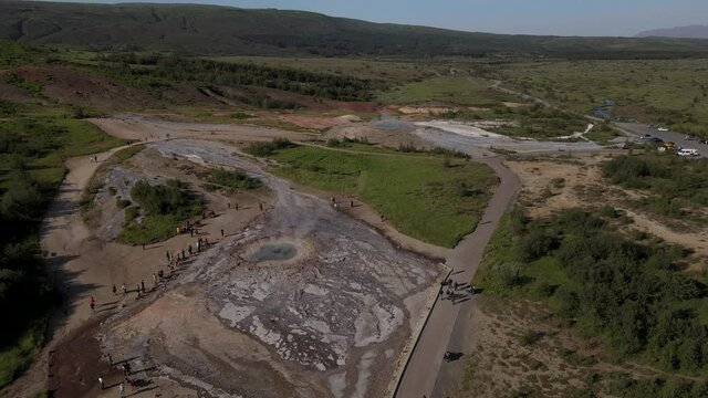 Aerial Cinematic footage of the Impressive Icelands Geysir Geisir in the Golden Circule, the geothermal activity and a attraction for tourists in Iceland	